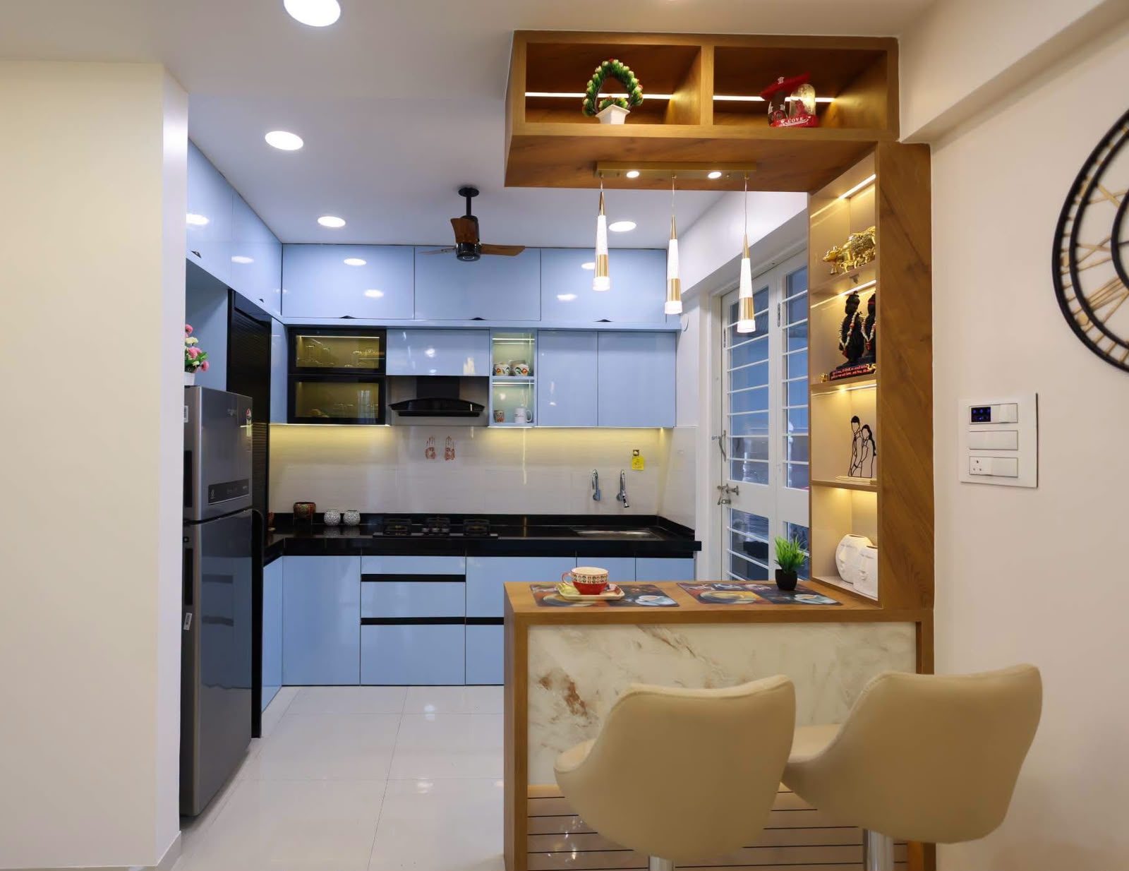 Powder-blue modular kitchen with breakfast counter